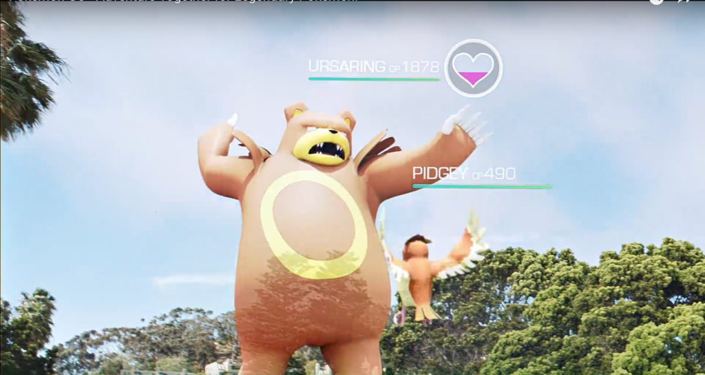 Image shows a capture from a Pokemon Go experience, showing two characters with trees and sky in the background.