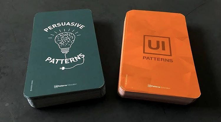 Photograph of the persuasive patterns deck stacked to the left of the UI patterns deck.