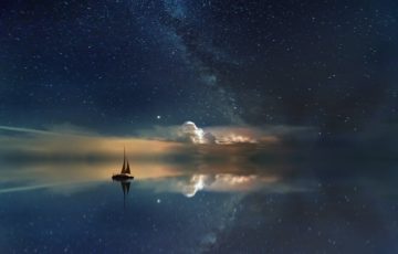 sailboat on the sea, under the stars at night